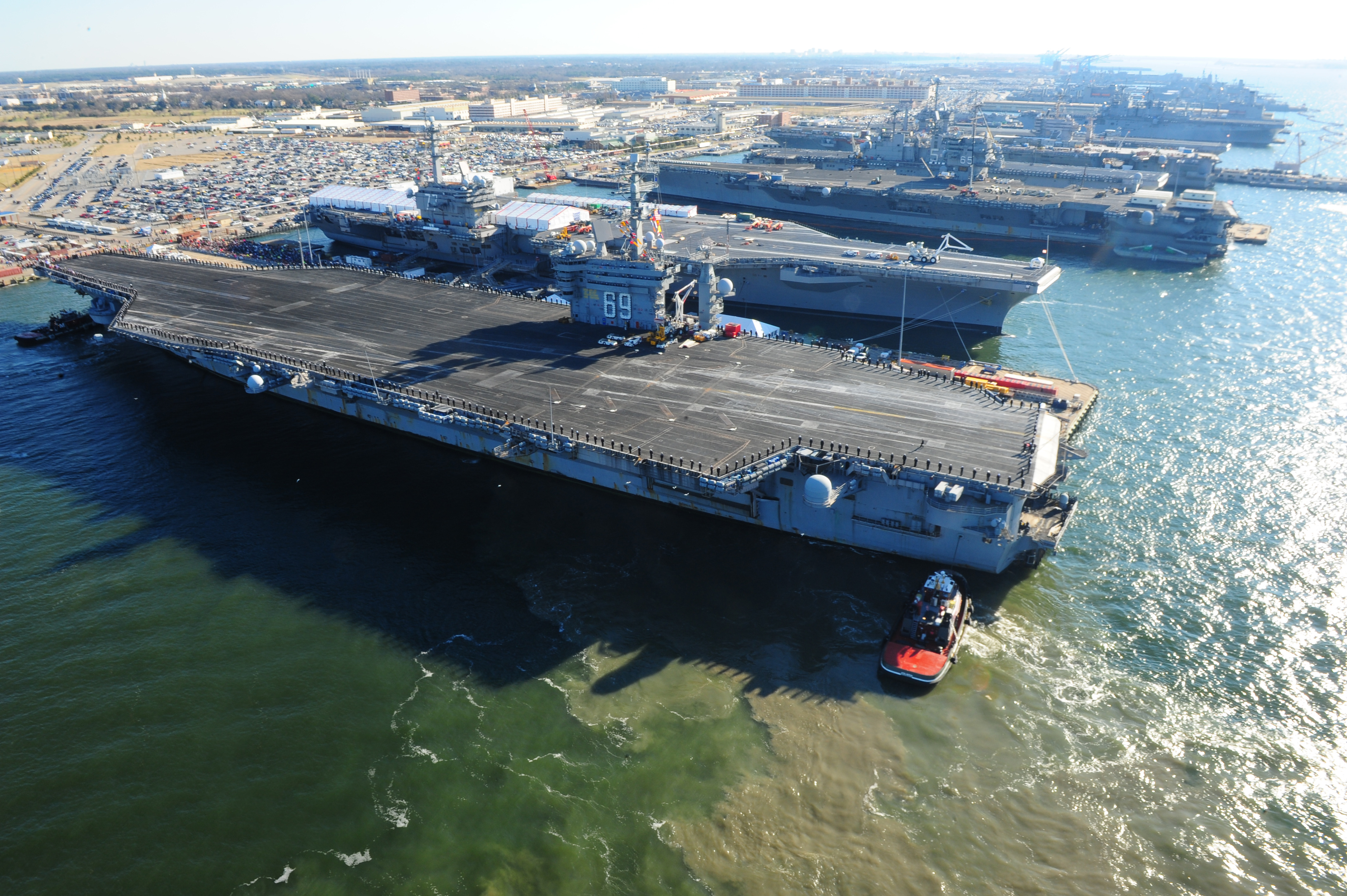 The aircraft carrier USS Dwight D. Eisenhower (CVN 69) makes its approach pierside at Naval Station Norfolk after a six-month deployment to the U.S. 5th and 6th Fleet areas of responsibility in support of Operation Enduring Freedom, maritime security oper