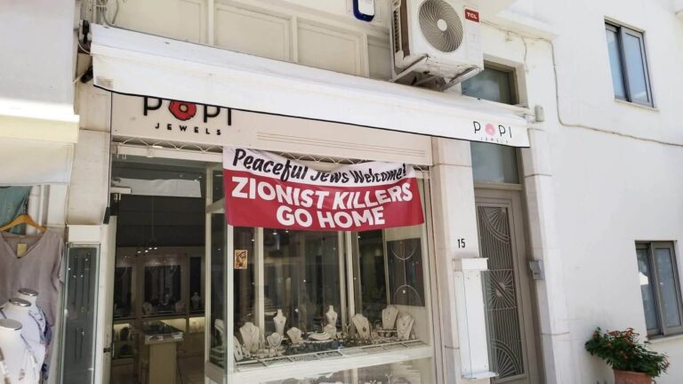 «Ειρηνόφιλοι Εβραίοι ευπρόσδεκτοι, σιωνιστές φονιάδες πάτε σπίτια σας!», έξω από καταστήματα στον Άγιο Νικόλαο